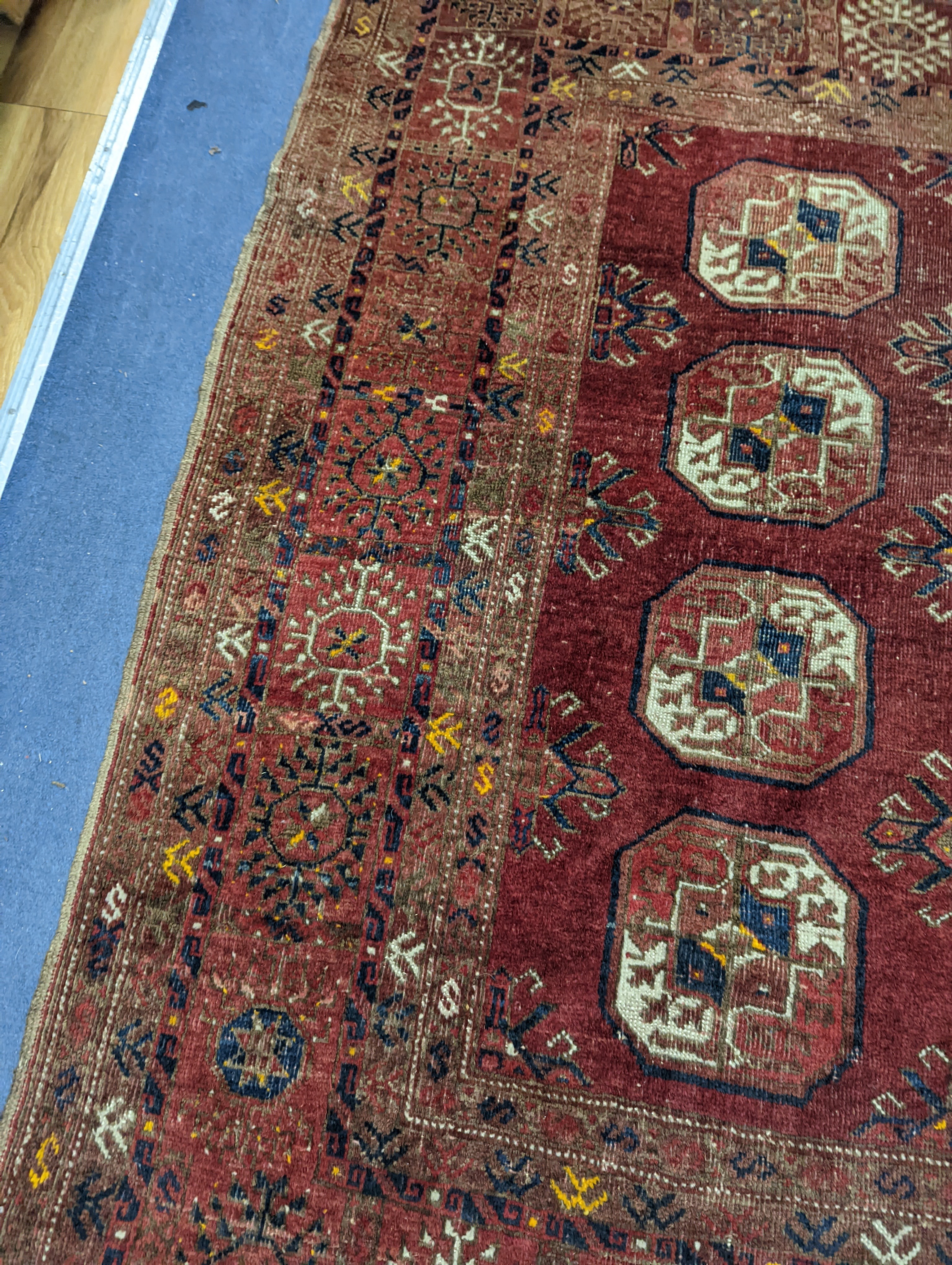 A Bokhara red ground rug, 200 x 114cm